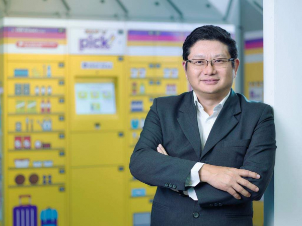 Professional business headshot of Pick Network Pte Ltd CEO in front of their company lockers. Studio photoshoot with professional lighting on location. Senior management portraiture.