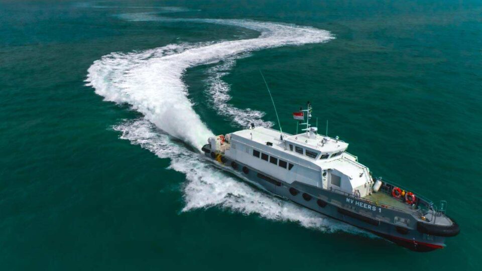 Aerial photograph of the fast crew boat MV Heers under way at speed — industrial photography Singapore, marine aerial, vessel drone photography