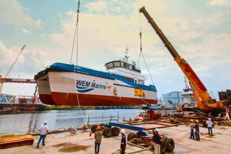 WEM Marine hull on the slipway with a crawler crane and yard team during a boat launch — Singapore industrial photographer, shipyard photography