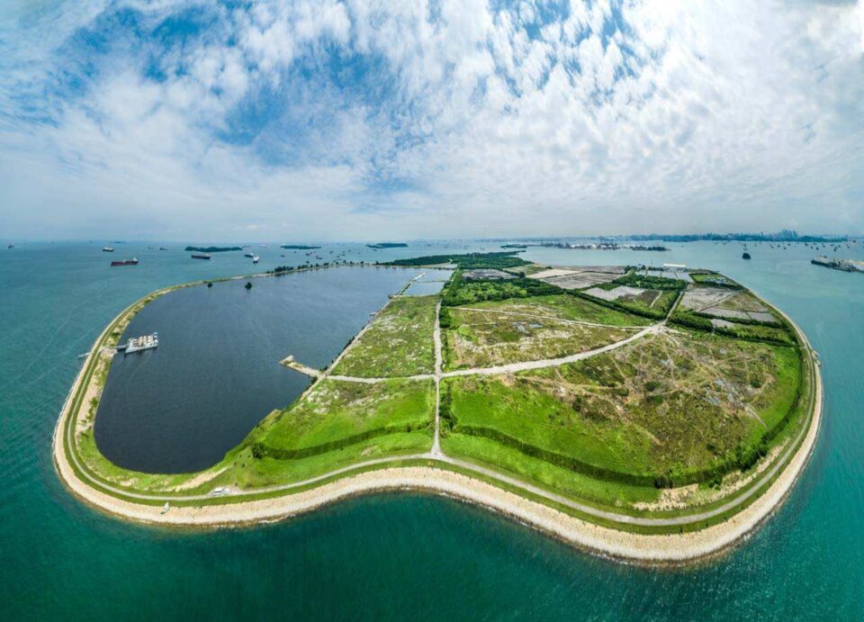 Aerial view of Semakau Landfill with barges moored along the containment bund — industrial photographer Singapore, waste management photography, aerial drone photography