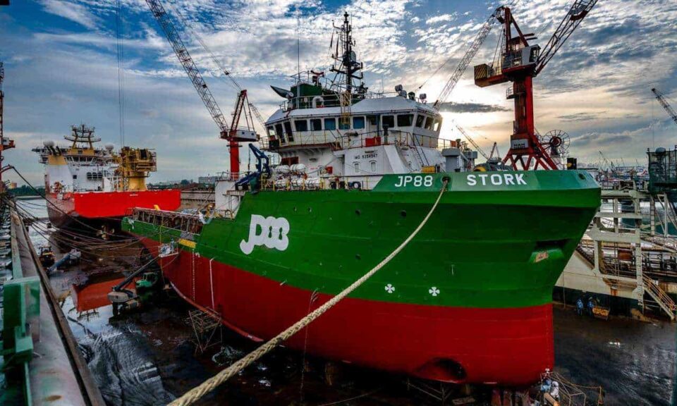 Green hulled vessel Stork alongside at Keppel Harbour during refurbishment — industrial photographer Singapore, ship repair photography