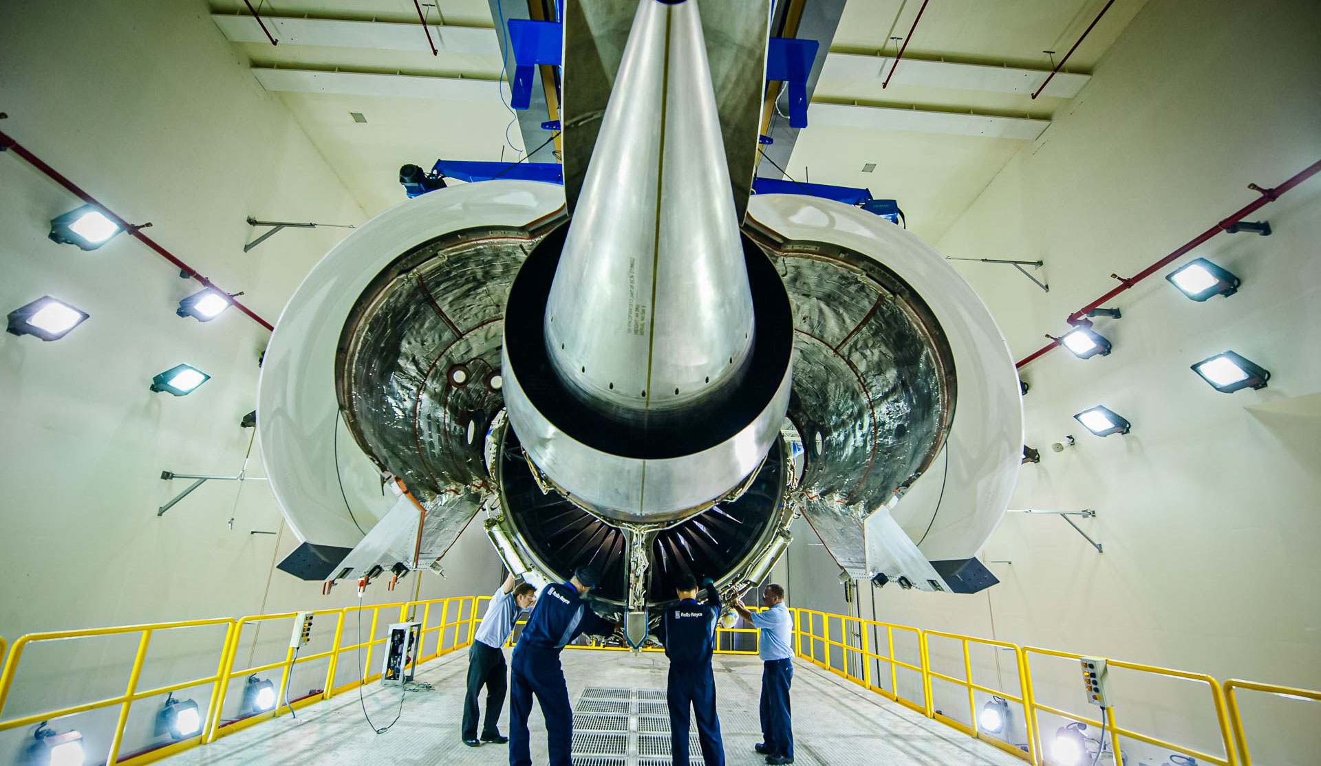 Rolls-Royce technicians beneath a turbofan engine at the Seletar Aerospace facility, Singapore aerospace photography by Tuckys