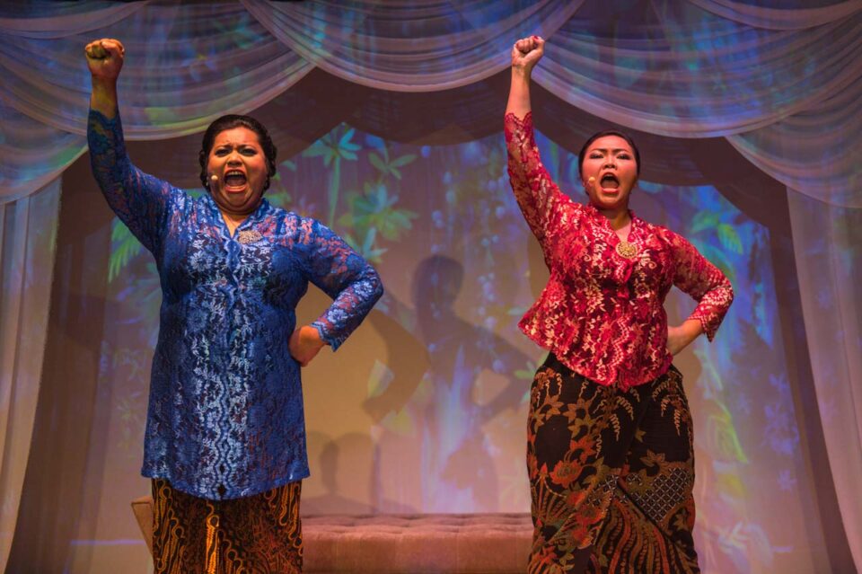 Singapore theatre photography: production photography. Aidli Mosbit and Siti Khalijah Zainal in kebaya, fists raised mid-shout, in Kebaya Homies