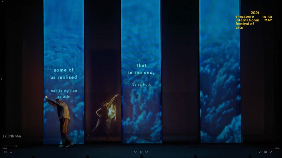 Singapore theatre photography: theatre video still. Video still from the opening of The Year of No Return: tall projection panels of blue water and cloud, with performers in silhouette